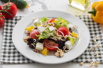 Fresh spring salad of vegetables, feta cheese and soybean sprout. Dressed with olive oil. Cook at home.