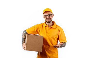 Friendly young delivery man holding big boxes in his hands on a white background