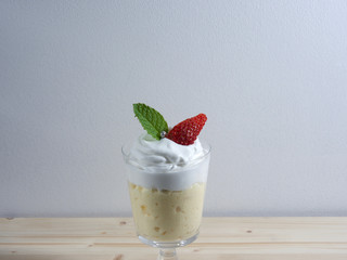 Strawberry dessert with jelly and whipped cream, decorative silver ball