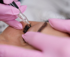 Close up permanent eyeliner tattoos enhancement coloring in spa