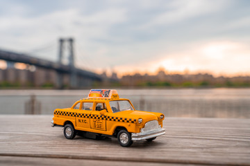Classic taxi model parked at Domino park sign in Williamsburg, New York.