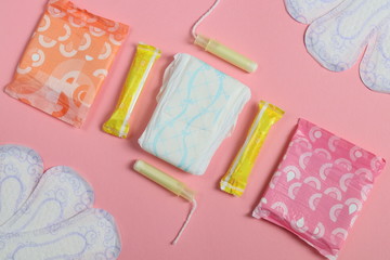 Pink and blue, pink background and women's pads with tampons.