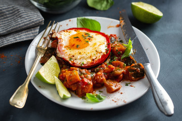 Fried egg with vegetables on plate