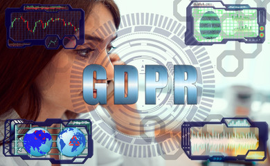 Hands of a business women usingsmart phone and futuristic holographic screen in the graphs of the exchange rate and the inscription: GDPR