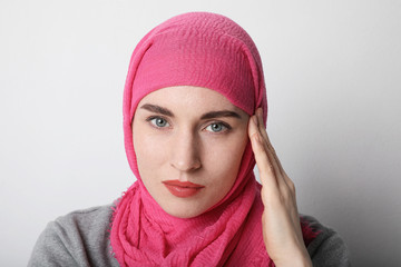 Headshot portrait of a muslim woman wearing a head scarf hijab and smilling. Isolated.