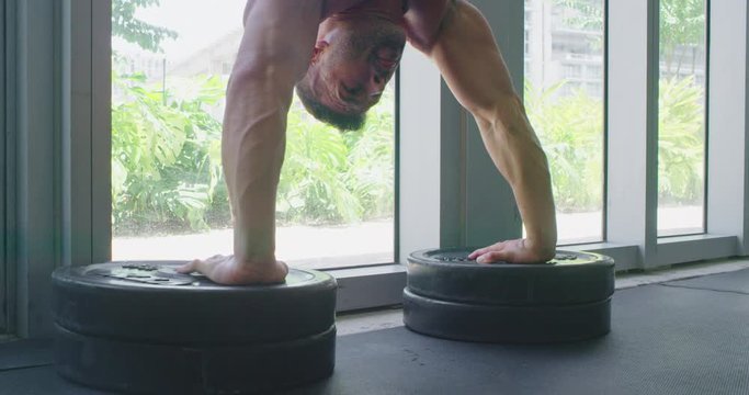 Athletic man doing handstand push up