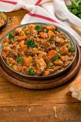 Beef Curry Stew with Potatoes and Carrots on Wooden Background. Selective focus.