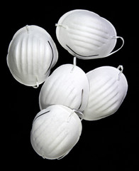 A bunch of face masks on a black background