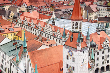 Aerial view of former town hall Altes Rathaus, bell tower with sundial above dense row of historic buildings near Marienplatz square in downtown / city centre Altstadt, Munchen Bayern Germany Europe