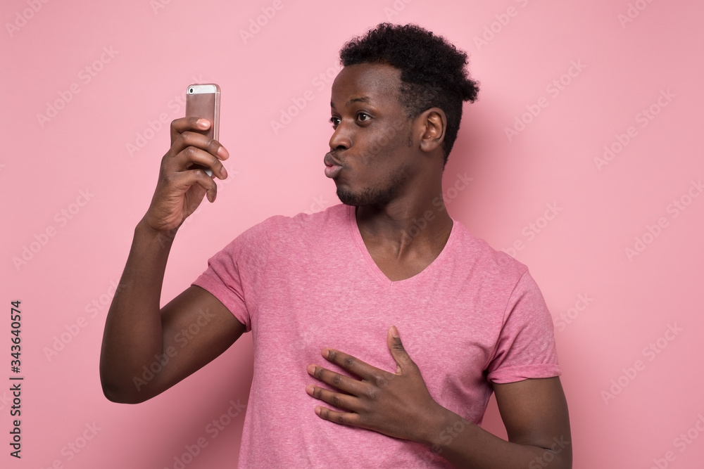 Canvas Prints African American man make selfie on gadget. Studio shot