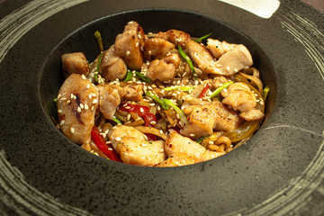 Noodles with meat and vegetables close-up, top view