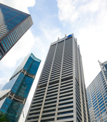 Fototapeta na wymiar Modern buildings of Singapore skyline landscape in business district with blue sky.