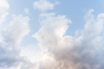 Pastel blue   sky background with fluffy  clouds 