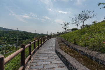 Fototapeta na wymiar Perspective view of stone road corridor on park slope