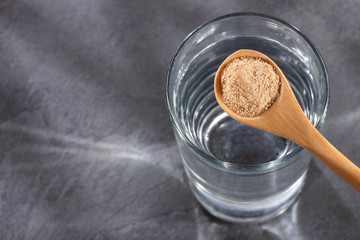 Spoon with maca flour to mix with water - Lepidium meyenii.
