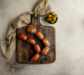 spanish food - sausages on the cutting board - butifarra blanca, chorizo, morcilla de cebolla