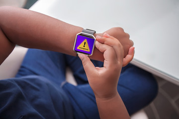 An emergency alert message being received on a wireless smart wristwatch while sitting in front of...