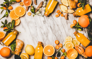 Immune boosting vitamin health defending drink. Flat-lay of fresh turmeric, ginger, citrus juice...