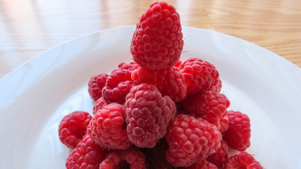 raspberries on a white plate