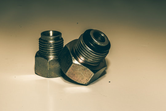 Close-up Of Bolts And Nuts On Table