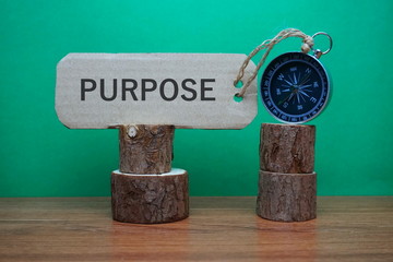 Conceptual Image: Magnetic compass with paper tag written Purpose, selective focus.