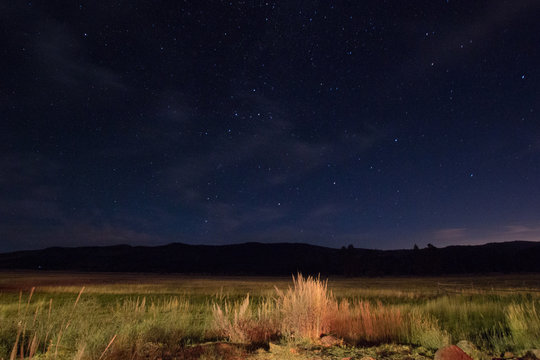 Scenic View Of Field Against Sky At Night