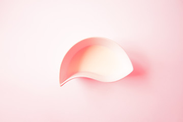Overhead View of a Cup of milk on a pink background