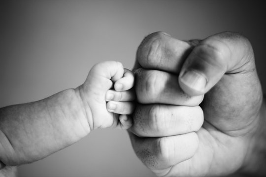 Cropped Hands Of Family Giving Fist Bump