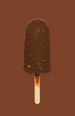 chocolate outer popsicle with blueberry sauce inside on brown background