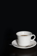 a cup of coffee on a black background
