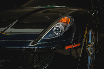 Front view of a italian supercar. Close-up of supercar headlight.