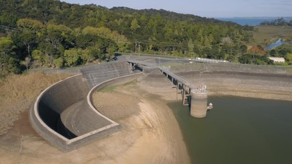 Nihotupu Dam, Auckland, New Zealand, 2020. Aerial flying over spillway and water reservoir at a low level because of a drought