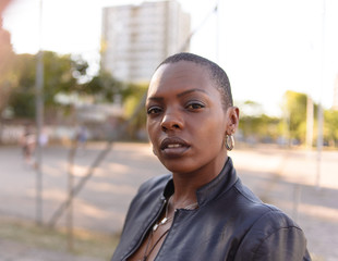 Black woman with short hair on an urban background