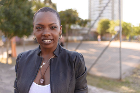 Black woman with short hair on an urban background