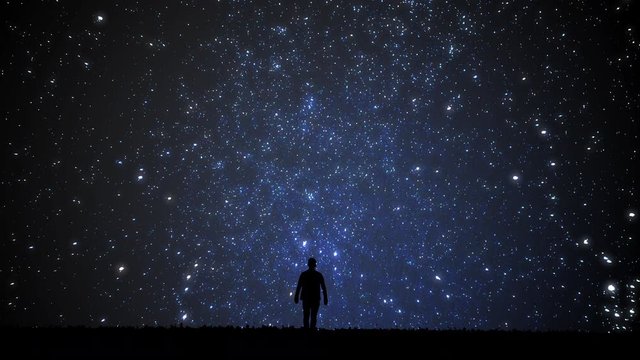 Man looking at the stars. Alone man looking at starry sky. Night sky. 