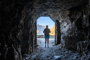 Woman Hiker Stands at The Entry of Ptarmigan Tunnel