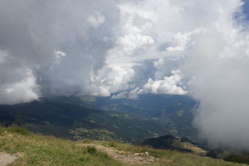 Thick rainy clouds above mountains lanscape in summer time.