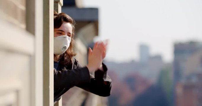 People applaud hospital staff in Europe. Coronavirus pandemic in Italy and Spain. People rejoice over quarantine. Doctors and rescuers during an epidemic. Street in Milan
