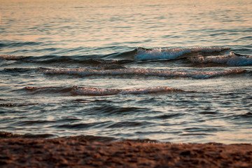 Waves of Lake Michigan on the beach at sunset