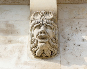 Faces carved into the Pont Saint Michel bridge in Paris, France