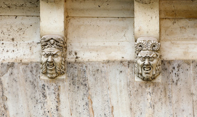 Faces carved into the Pont Saint Michel bridge in Paris, France