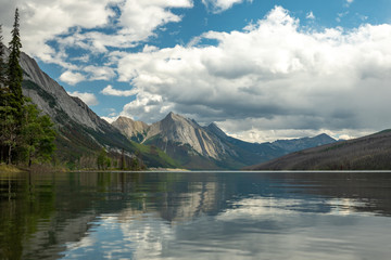 Lake in the Mountains during Cloudy Skies with reflection in the lake with calm waters in the Canadian rockies