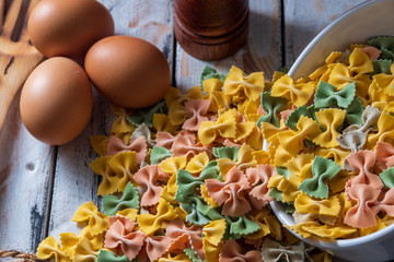 
dry pasta on rustic wood and fresh eggs