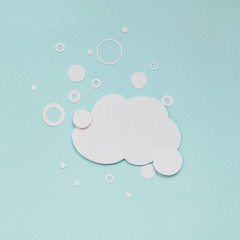 Cloud of foam with soap bubbles on pastel light-blue background. Flat paper cut illustration. Soapy Speech cloud. Trendy chat bubble in covid-19 pandemic time.