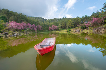 Beautiful scenery of fishing boat on lake with a reflection in the water