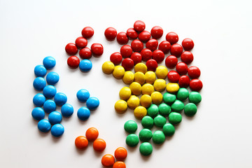 Colorful milk chocolate on white background