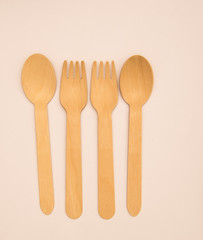 Wooden eating utensils isolated against white background