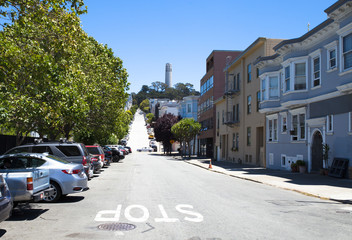 Fototapeta premium San Francisco, California, USA-: street painted stop with with Coit Tower in the background in San Francisco