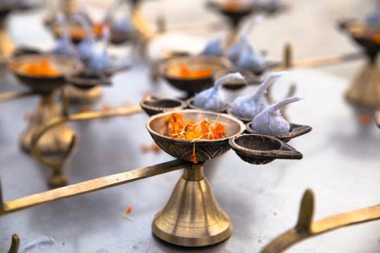 An Oil Diya Lamp Made By Metal With Flower Petals In It For Performing Puja On Diwali Or Ganga Aarti