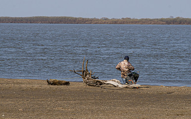a fisherman catches fish on the Amur river